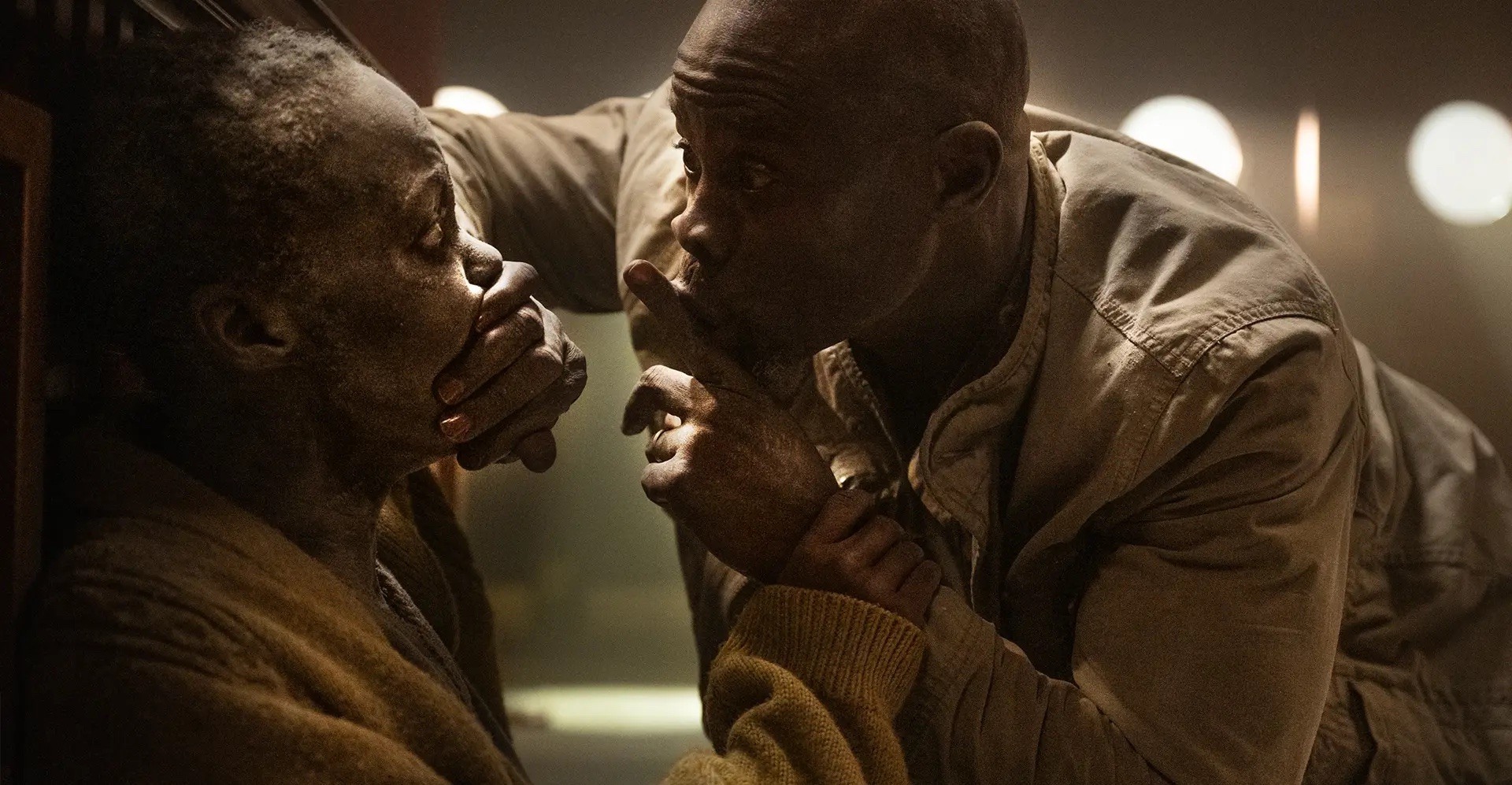 A man covering Sam's (Lupita Nyong'o) mouth in 'A Quiet Place: Day One'