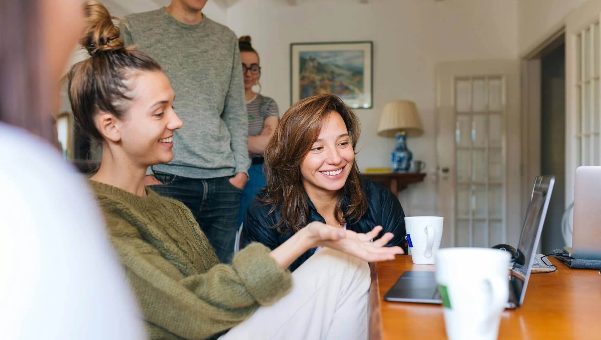 A group looking at a laptop in an apartment; Why Feedback Is Vital for Every Screenwriter