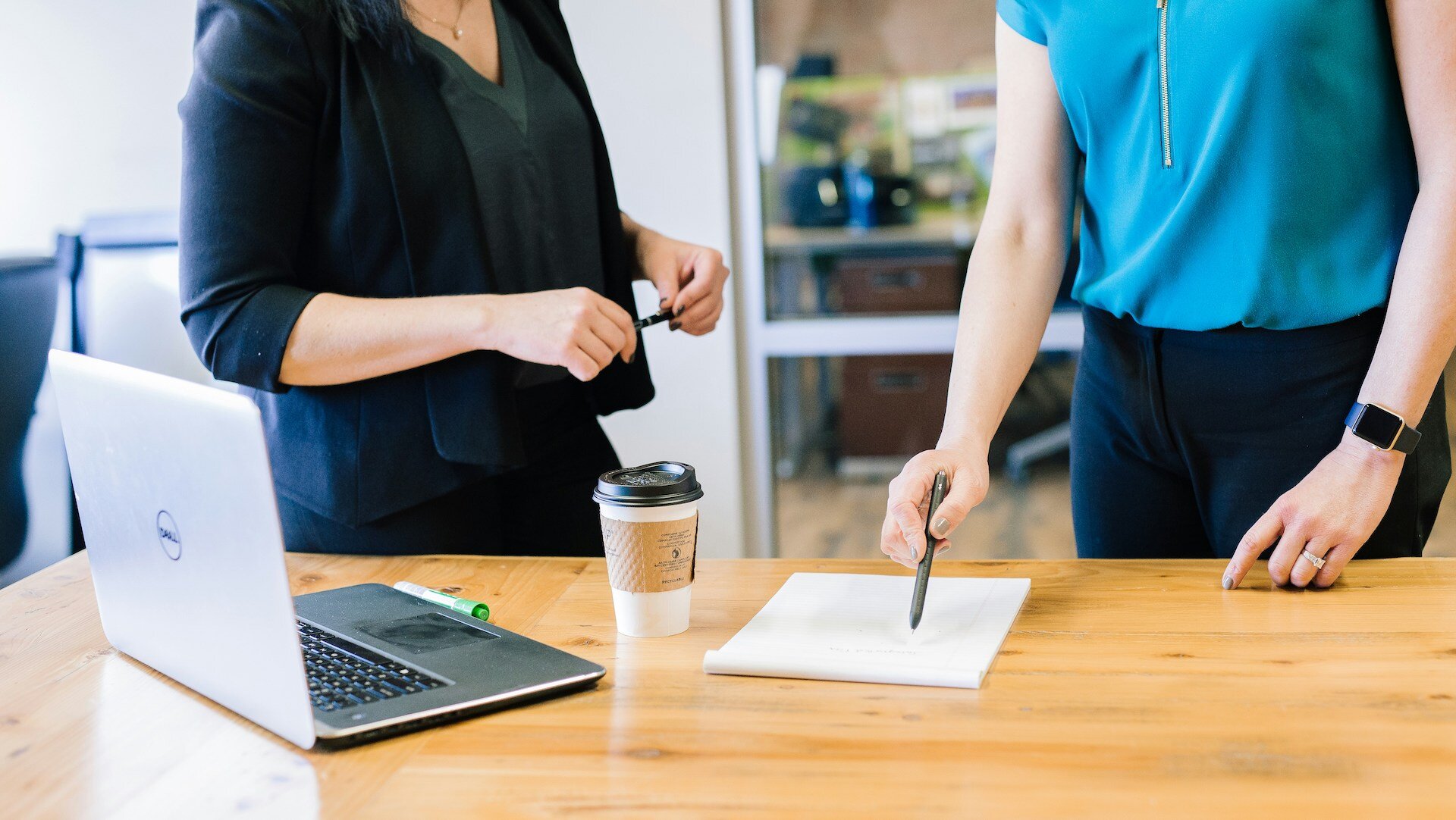 Two women in a meeting looking over notes; This Is What Managers Look for in a Script