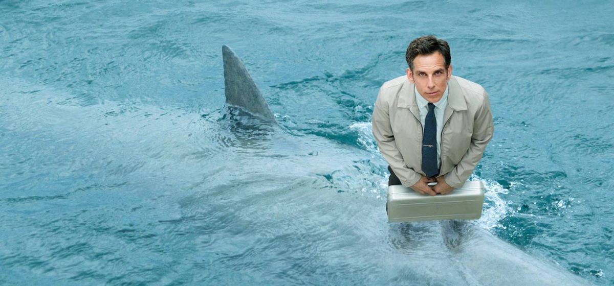 Walter Mitty (Ben Stiller) standing on a shark in the ocean in 'The Secret Life of Walter Mitty'